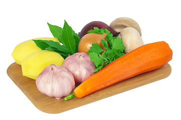 Image showing Board with potatoes, garlic, carrots, mushrooms