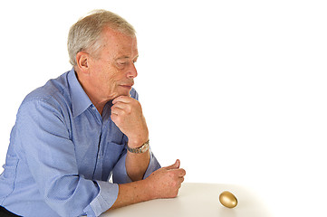 Image showing Senior man with golden egg