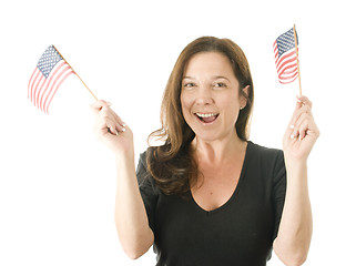 Image showing happy woman waving patriotic American flags