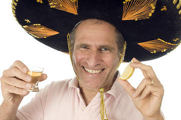 Image showing middle age senior tourist male wearing Mexican somebrero hat dri