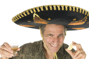 Image showing middle age senior tourist male wearing Mexican somebrero hat dri