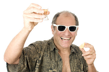 Image showing middle age senior tourist male sun glasses  drinking tequila sho