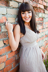 Image showing beautiful girl against old brick wall