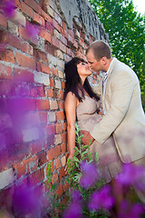 Image showing Romantic kiss near old brick wall