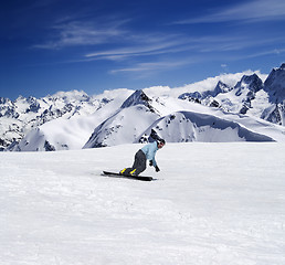 Image showing Snowboarding in mountains