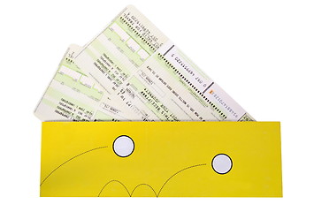 Image showing Airtickets to yellow envelope on white background