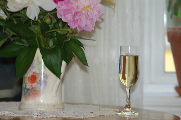 Image showing Glass of white wine and flowers