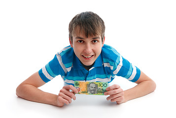 Image showing Happy smiling boy holding money