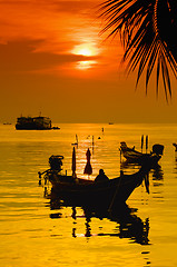 Image showing Sunset with palm and boats on tropical beach