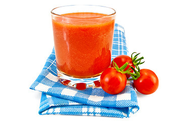 Image showing Juice tomato in glass on a napkin