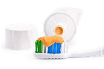 Image showing Toothbrush with orange toothpaste