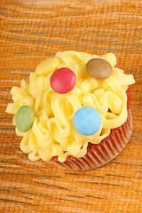 Image showing Fancy yellow cupcake with confectionery