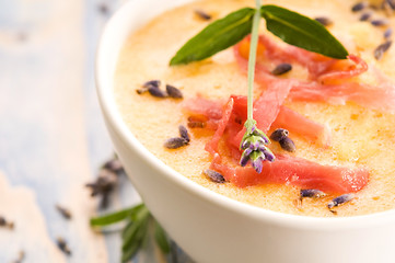 Image showing fresh melon soup with parma ham and lavender flower