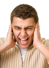 Image showing man shuts his ears hands