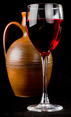 Image showing Pitcher and a glass of red liquid 