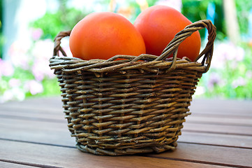 Image showing straw basket full of  tomatoes