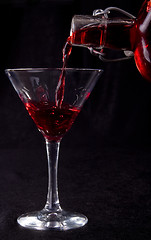 Image showing red liquid poured into a cocktail glass 