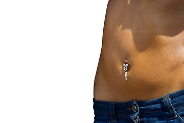 Image showing Pierced navel of a young woman in bluejeans skirt.