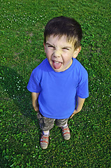 Image showing Young boy tongue sticking