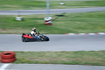 Image showing Boy drive car on kart track