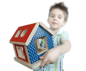 Image showing Boy presenting wood colorful house toy 