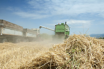 Image showing Tractor and combine harvesting