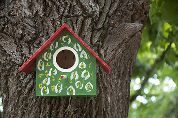 Image showing Home-made bright colored bird house. 