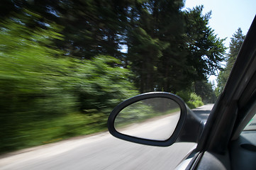 Image showing Blue car in motion 