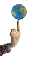 Image showing Hand holding globe on finger