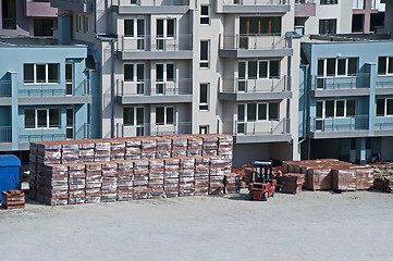 Image showing Pallets of bricks in front of new building