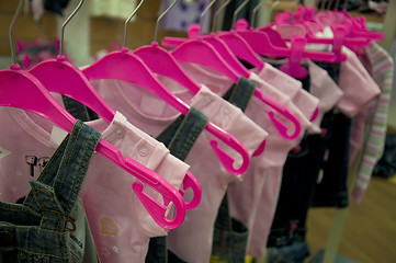 Image showing Clothes hang on hangers in shop