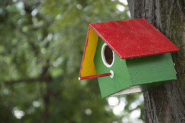 Image showing Home-made bright colored bird house 