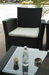 Image showing Coffee and a bottle of mineral water 