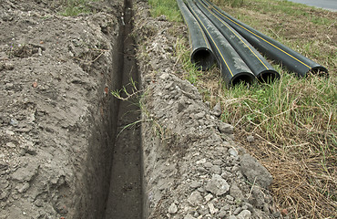 Image showing Plastic pipes in a ditch