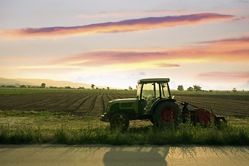 Image showing Plowed land and tractor 