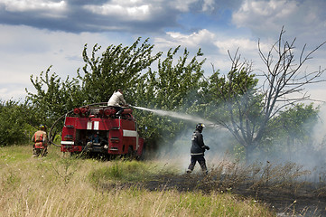 Image showing Firefighters extinguish a fire