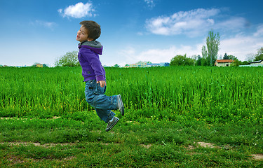 Image showing Jumped boy on green meadow