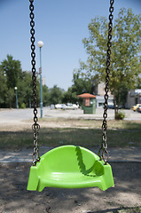 Image showing Empty green swing with chain