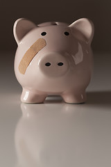 Image showing Piggy Bank with Bandage on Face