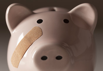 Image showing Piggy Bank with Bandage on Face