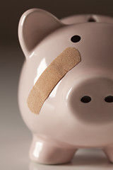 Image showing Piggy Bank with Bandage on Face