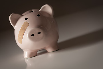 Image showing Piggy Bank with Bandage on Face