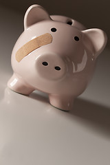 Image showing Piggy Bank with Bandage on Face