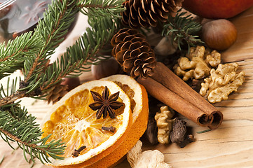 Image showing Different kinds of spices, nuts and dried oranges - christmas de