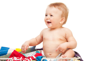 Image showing Laughing baby sitting in clothes