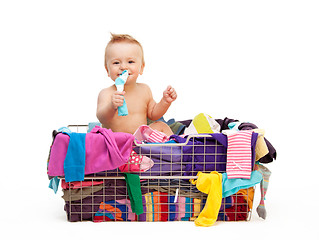 Image showing Toddler in basket with clothes