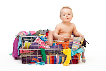 Image showing Happy baby in basket with clothes