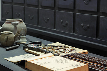 Image showing abacus and book on the table in a chinese old shop