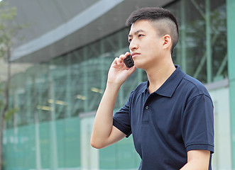 Image showing young man talking phone outdoor