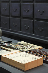 Image showing abacus and book on the table in a chinese old shop